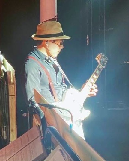 David Tran playing electric guitar on stage